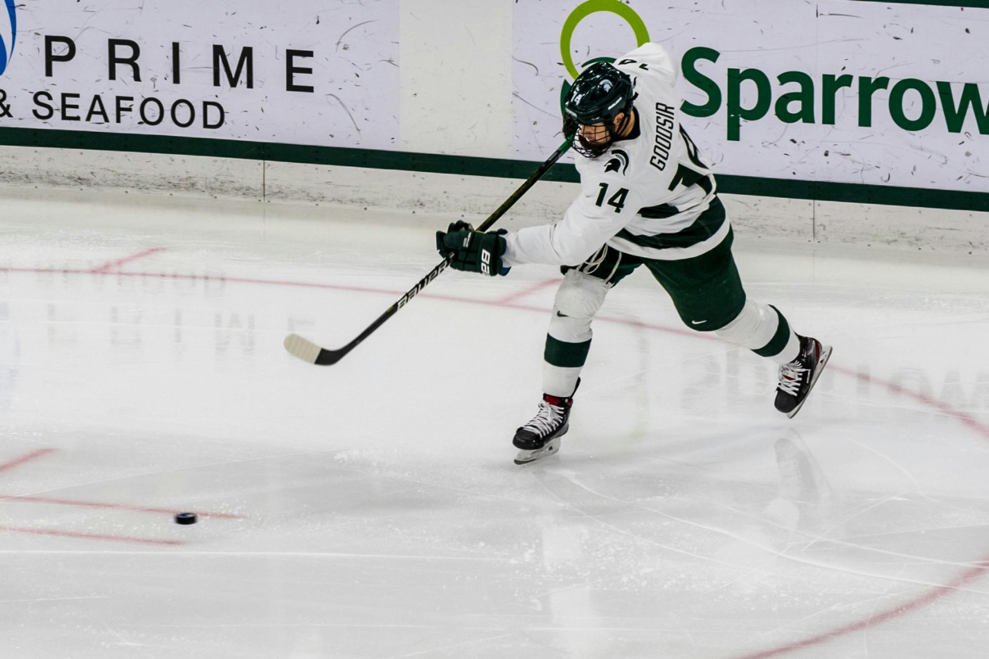 <p>Sophomore forward Adam Goodsir (14) shoots the puck against Notre Dame. The Spartans were defeated by the Fighting Irish, 2-1, at Munn Ice Arena on November 22, 2019. </p>