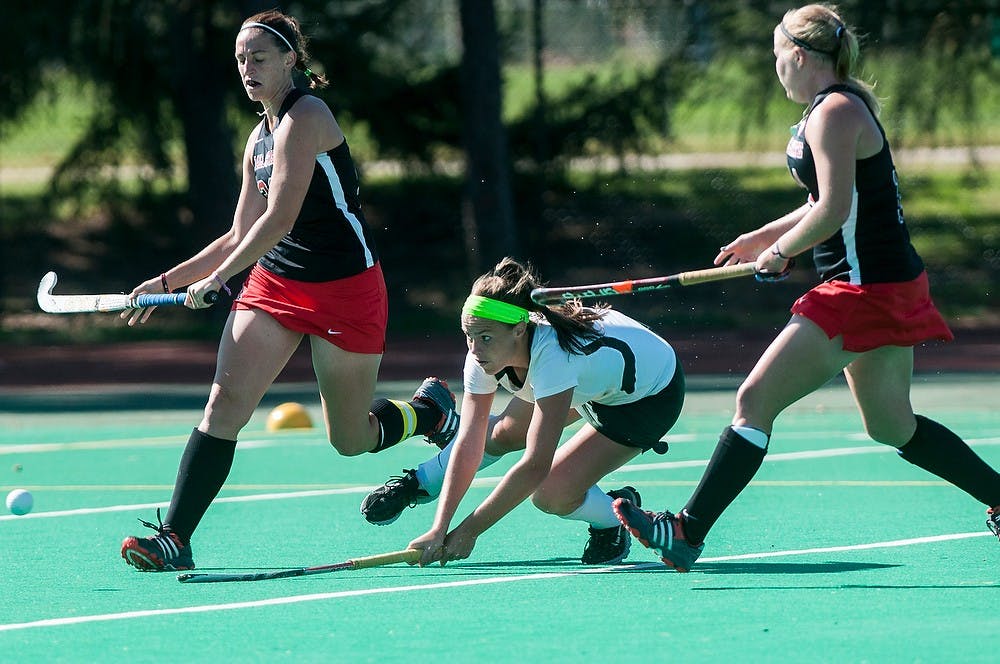 	<p>Junior forward Abby Barker dives for the ball Oct. 13, 2013 at Ralph Young Field. The Spartans defeated the Cardinals, 8-0. Khoa Nguyen/The State News</p>