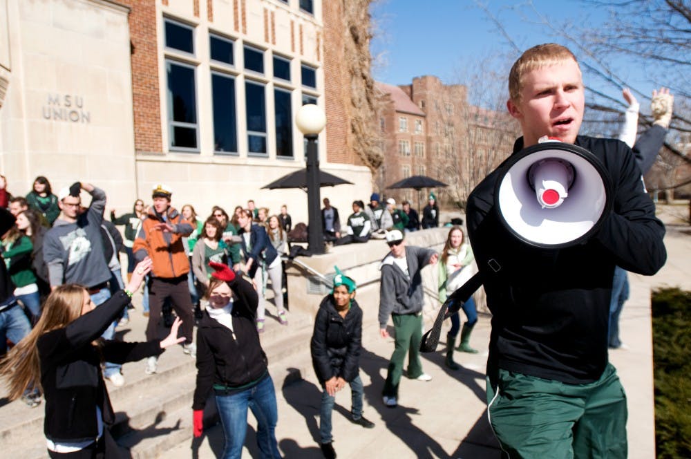 Kinesiology sophomore Brent Money helps teach a choreographed dance to a group of students Friday at the Union. The dance was part of a video being made to convince Daniel Tosh to come to MSU. Tosh hosts the show Tosh.0 on Comedy Central. Kat Petersen/The State News