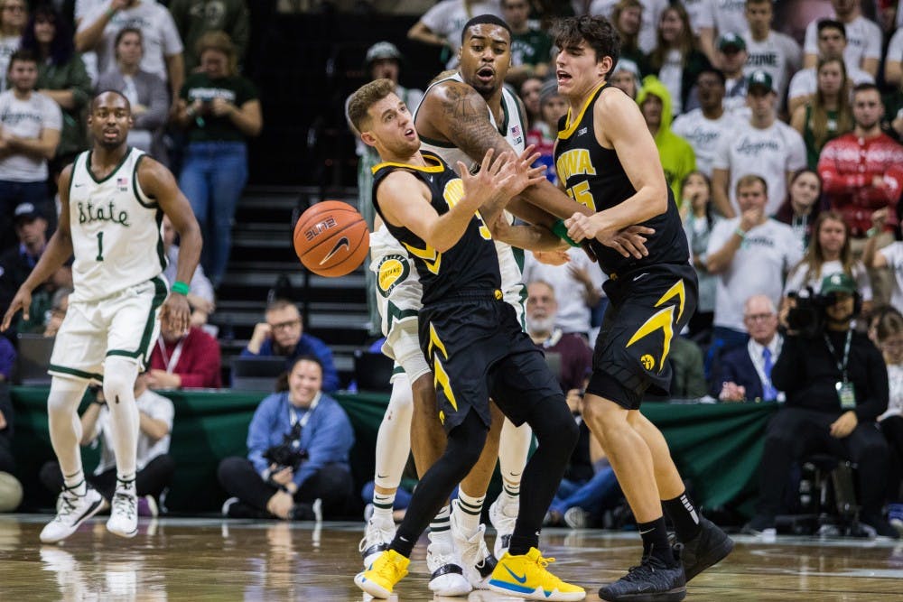 Junior forward Nick Guard (44) blocks Iowa players during the game against Iowa University at Breslin Center on Dec. 3, 2018. The Spartans defeated the Hawkeyes, 90-68.