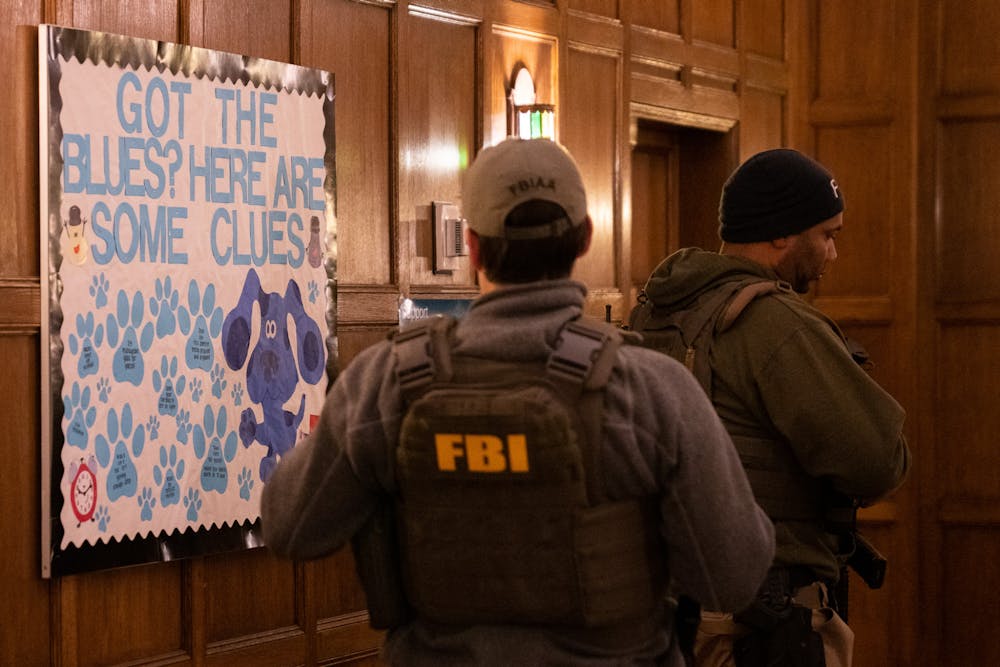 <p>FBI agents and police officers inside Campbell Hall, the building across from the MSU Union where a mass shooting took place on the night of Feb. 13, 2023. Not. The officers were still searching for the attacker hours later, making their way in and out of Campbell Hall, giving sporadic direction to the students that were sheltered inside. </p>