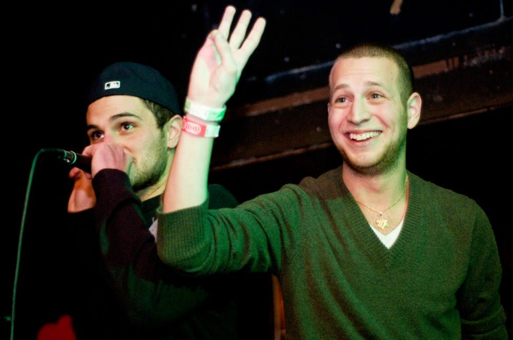 Advertising senior Dirk Roberts, left, and psychology senior Jordan Rosenbaum call for bids Wednesday at the Landshark, 101 East Grand River Ave. Rosenbaum was auctioned off as a date for the Kosher Meet Market, a fundraiser organized by the Hillel Jewish Student Center. Matt Radick/The State News