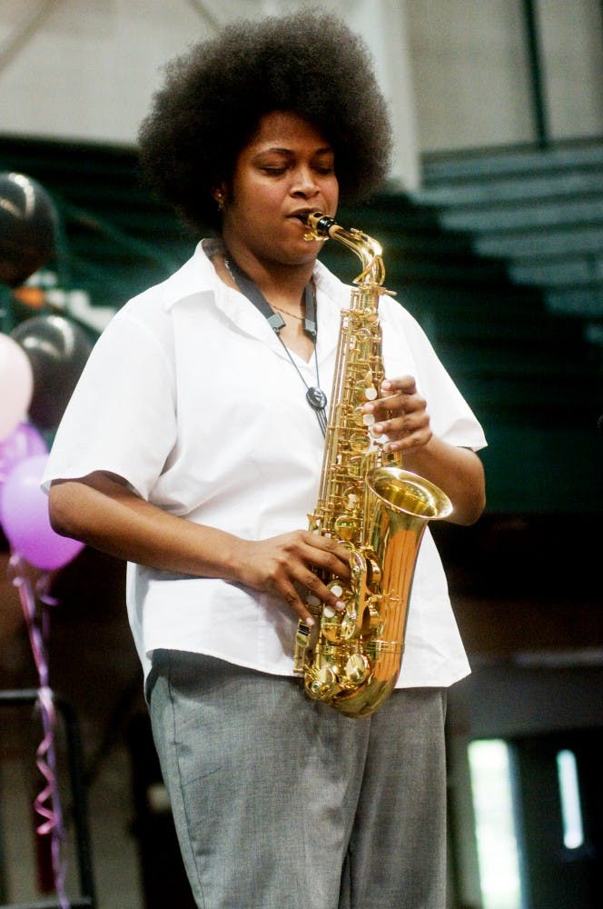 Music education senior Jessica Robins plays the saxophone Saturday evening at Cultural Remix held at Jenison Fieldhouse. Cultural Remix is a cultural celebration which showcases local performers and artists. Samantha Radecki/The State News 