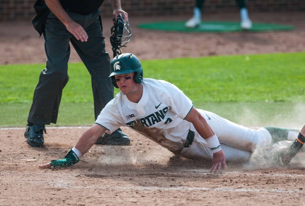 <p>Junior infielder Marty Bechina (2) slides on to home base during the game against Ohio State on May 17, 2018 at McLane Baseball Stadium. The Buckeyes defeated the Spartans, 10-8. (Annie Barker | State News)</p>