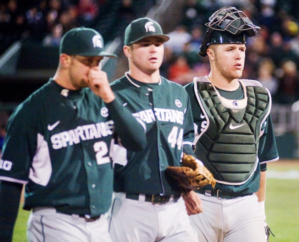 From left, right hand pitcher Joe Zwierzynski, first baseman and outfielder Ryan Jrill, and catcher and first maseman Blaise Saslter walk back to the field at the seventh innings.The Spartans fell to the Lugnuts by 7-0 Thursday evening at Cooley Law School Stadium. Justin Wan/The State News