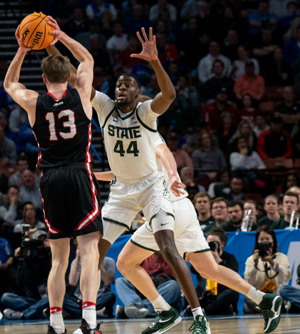 <p>Senior forward Gabe Brown (44) attempts to block a pass by redshirt junior guard Michael Jones (13) during Michigan State&#x27;s win over the Davidson Wildcats on March 18, 2022.</p>