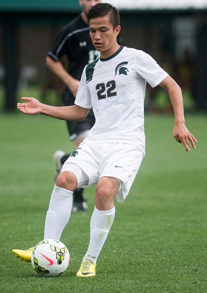 <p>Freshman midfielder Ken Krolicki kicks the ball Aug. 24, 2014, at DeMartin Soccer Stadium at Old College Field during a game against Stevens Institute of Technology. The Spartans defeated the Ducks, 4-0. Erin Hampton/The State News</p>