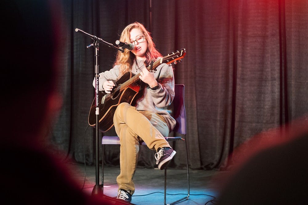 <p>English freshman Amanda Tabbey sings on March 28, 2014, at International Center during the Spartan Voice singing competition. Tabbey heard about the event because she frequently attends the UAB open mic nights. She placed 2nd in the event. Betsy Agosta/The State News</p>
