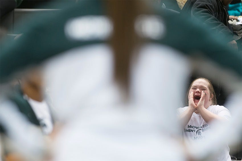 <p>Grand Ledge, Mich., resident Stephanie Russell cheers on the Spartans as the starting lineup is introduced on the court Feb. 24, 2014, before the game against Minnesota at Breslin Center. Russell has attended every women's home basketball game for the past 14 years. Julia Nagy/The State News</p>
