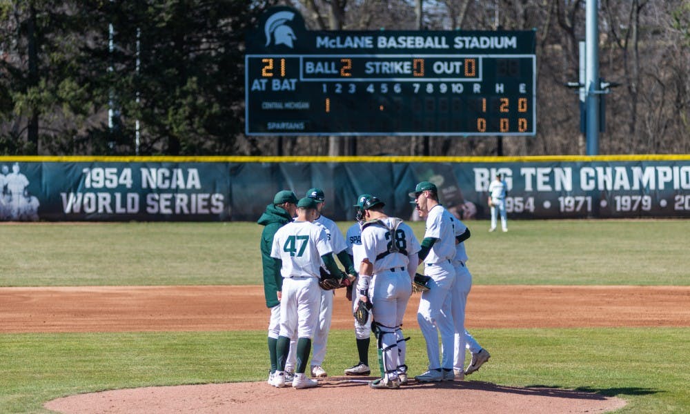 MSU players meet at the pitching mound in the first inning against Central Michigan. The Spartans lost the Chippewas, 6-8, at McLane Baseball Stadium on April 3, 2019.
