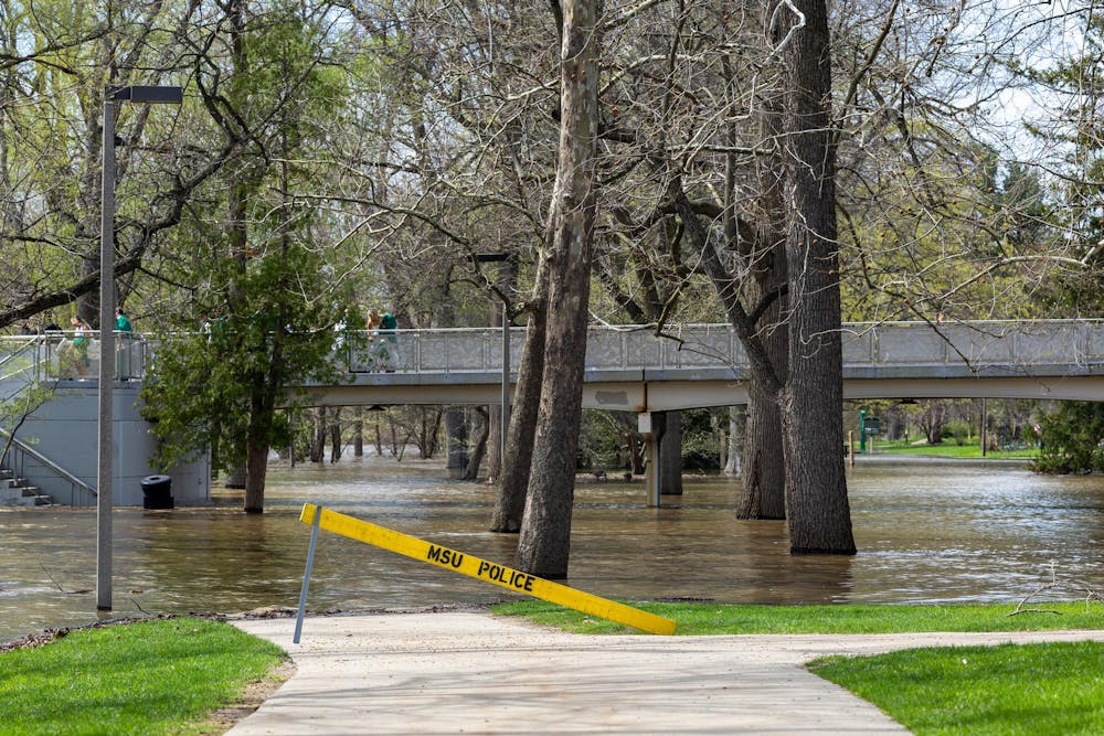 The Red Cedar River flood between the Main Library and Spartan Stadium in East Lansing, Michigan on Friday, April 17, 2026. 