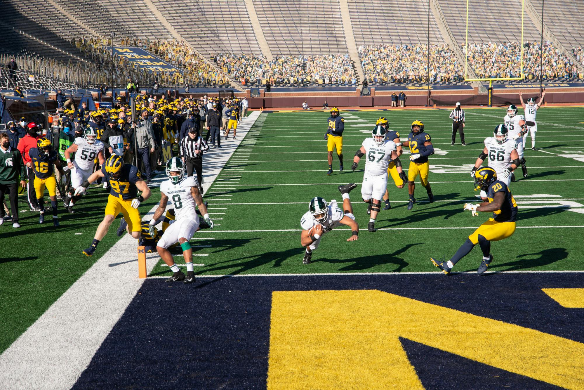 <p>Running back Connor Heyward (11) scores the game-winning touchdown for Michigan State in Ann Arbor, MI on Oct. 31, 2020.</p>