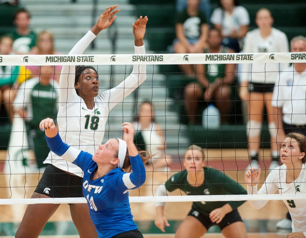 Junior middleblocker Alexis Mathews, left, attempts a block on Friday, Sept. 7, 2012 at Jenison Field House. MSU defeated IPFW, 3-2. Justin Wan/The State News