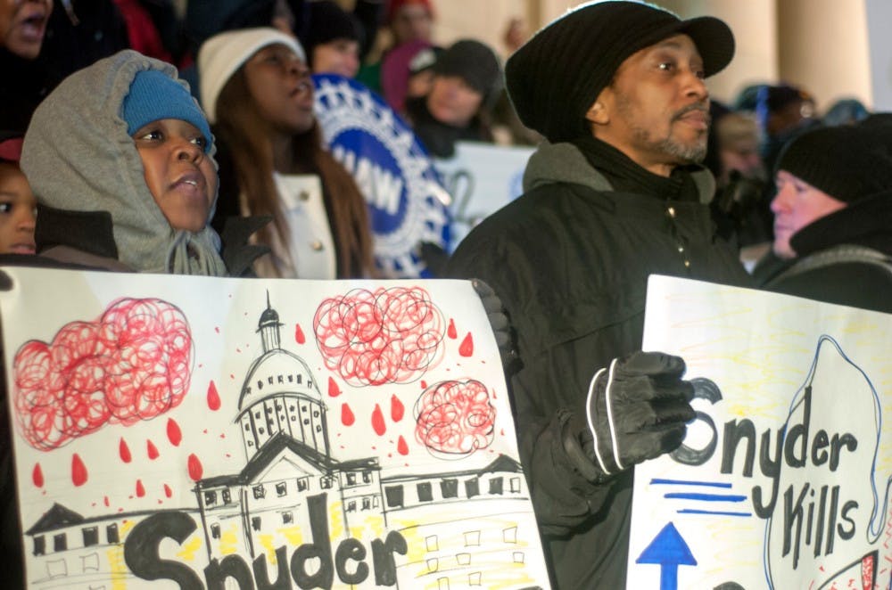 Detroit resident Alvina Bursey and Detroit resident Erik Bawsan protesting the Flint water crisis on Jan. 19, 2016 at State Capitol during the State of the State address. There were hundreds of people protesting outside the Capitol while Gov. Rick Snyder gave his State of the State address. 