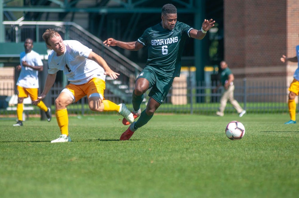 Senior forward Dejuan Jones (6) steals the ball during the game against Canisius on Aug. 31 at DeMartin Stadium. The Spartans defeated the Griffins; 3-2.