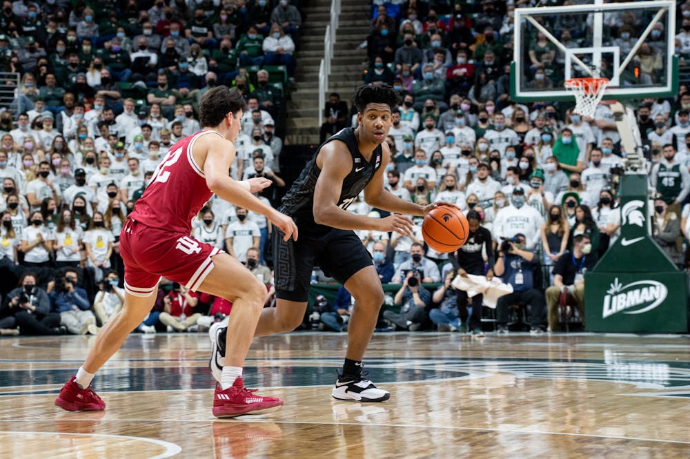 <p>Michigan State sophomore A.J. Hoggard (11) protect&#x27;s the ball from Indiana&#x27;s sophomore guard Trey Galloway (32) during Michigan State&#x27;s victory over Indiana on Feb. 12, 2022.</p>