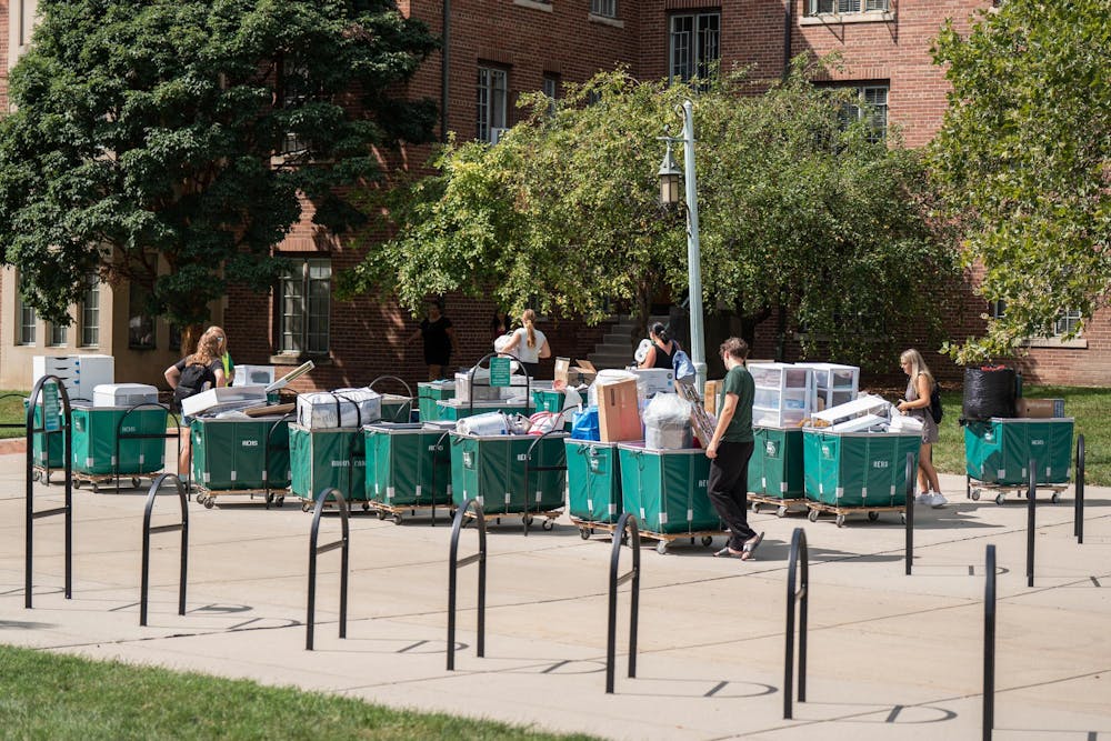 <p>Students gather with their move-in carts, awaiting their turn to bring items into their rooms during fall move-in at Yakeley Hall in East Lansing, Mich., on Aug. 25, 2026.</p>