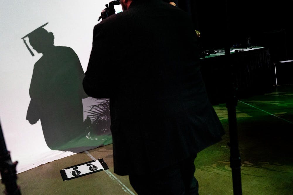 A graduate prepares to have their portrait taken after walking on stage during the Michigan State University College of Communication Arts and Sciences graduation ceremony at the Breslin Student Events Center on Michigan State University’s campus in East Lansing, Mich., on Friday, May 1, 2026.