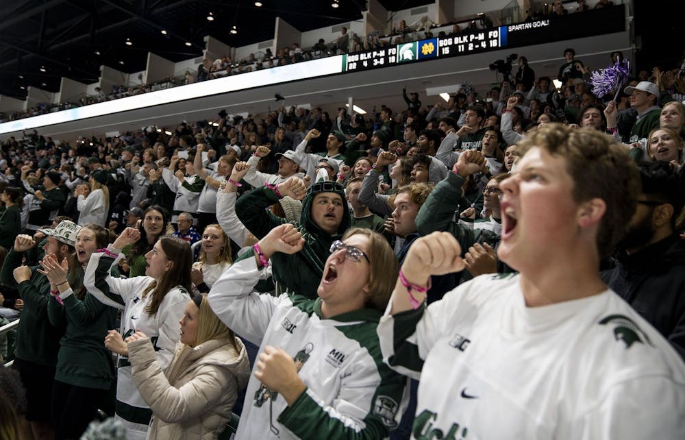 Michigan State University fans cheer in the students section after MSU scores against Notre Dame at the Munn Ice arena on Nov. 16, 2024. MSU defeated Notre Dame 4-3. 