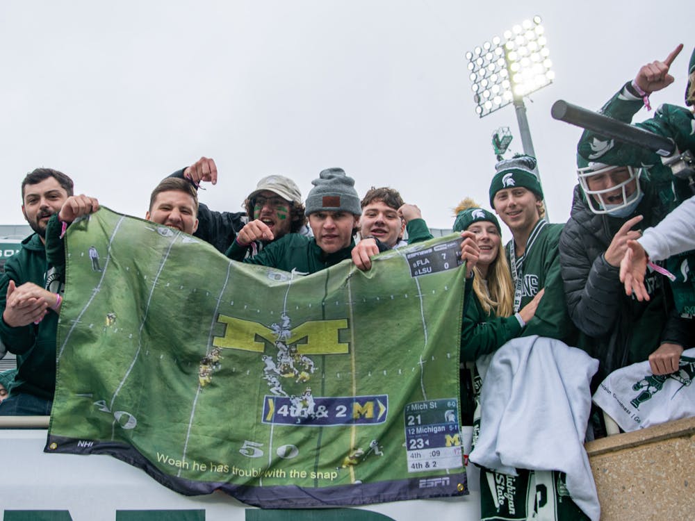 <p>Spartan fans hold up the infamous &#x27;Trouble with the snap&#x27; play on a flag in Spartan Stadium, on Oct. 30, 2021.</p>