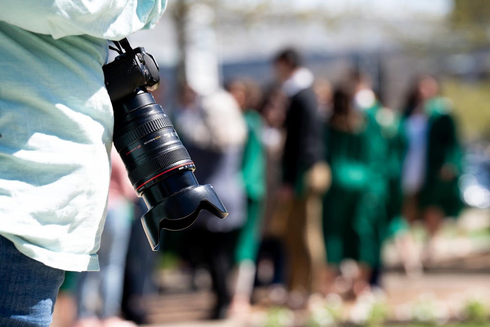 A photographer's camera at the Sparty Statue on campus on April 19, 2024. Seniors often have to wait in line for the best spots on campus to get their portraits taken. 
