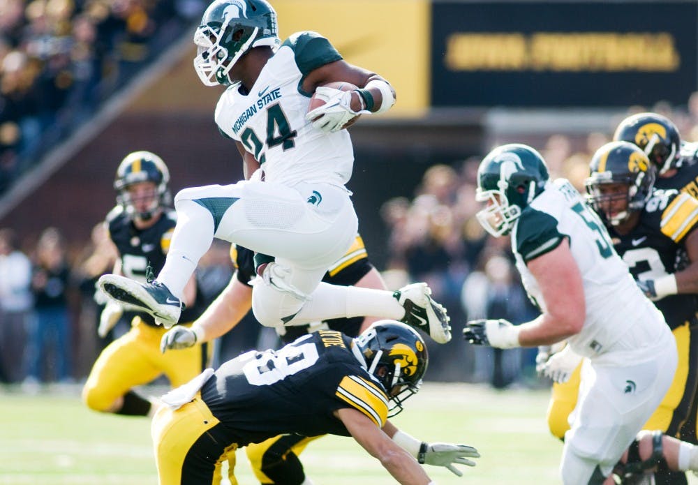 Sophomore running back Le'Veon Bell soars over Iowa cornerback Micah Hyde. The Spartans defeated the Iowa Hawkeyes, 37-21, Saturday afternoon at Kinnick Stadium in Iowa City, Iowa. Justin Wan/The State News