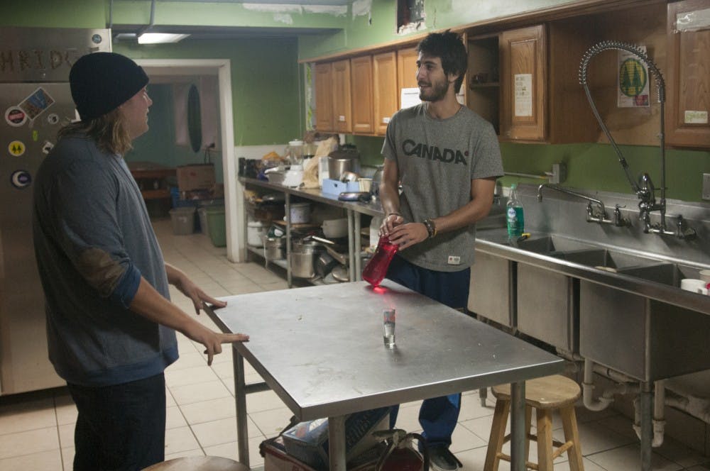 From left, fisheries and wildlife senior Logan Clark talks to computer science junior Gustavo Fulton on Sept. 29, 2016 inside Phoenix cooperative house. Clark has lived in Phoenix for two semesters, this is Fulton's first semester in the house.