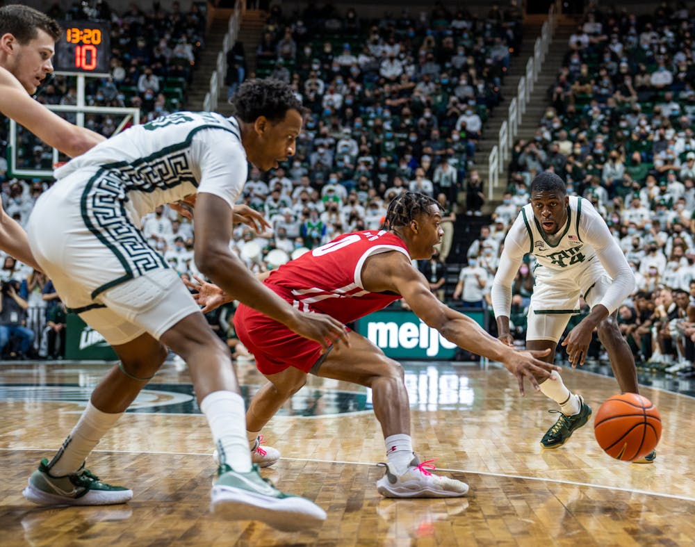 <p>Senior forward Gabe Brown (44) passes the ball to senior forward Marcus Bingham Jr. (30) in the second half. The Spartans fell to the Badgers, 70-62, at Breslin Student Events Center on Feb. 8, 2022. </p>