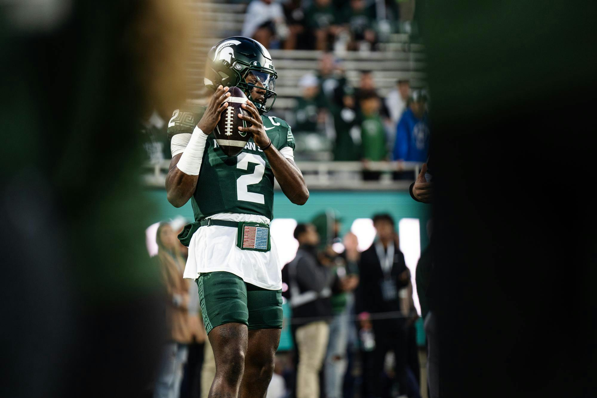 Michigan State sophomore quarterback Aidan Chiles (2) practices during warm-ups before the homecoming game against the University of Iowa at Spartan Stadium on Oct. 19, 2024.  