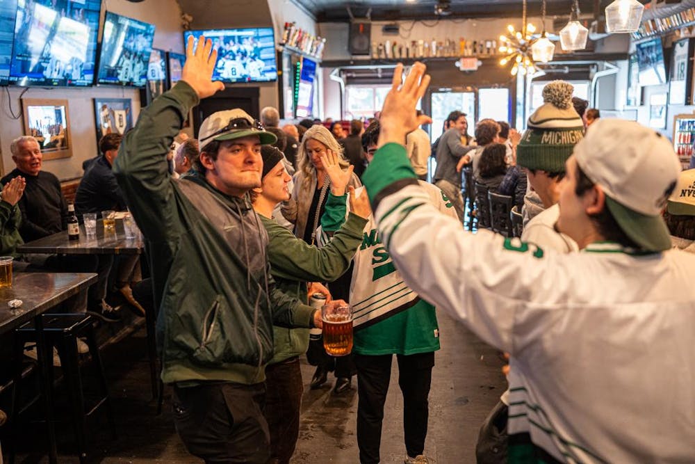 <p>MSU Hockey fans at Lou and Harry's Bar and Grill in East Lansing, MI celebrate a goal as the Spartans took on the Wisconsin Badgers on March 28, 2026. The Spartans would eventually fall to the Badgers in overtime, 4-3.</p>