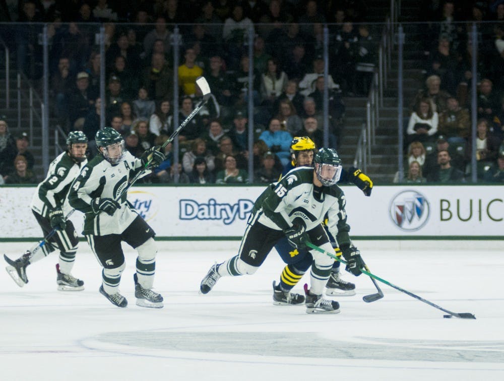 Junior forward Mackenzie MacEachern maintains control of the puck during the first period of the game against Michigan on Jan. 8, 2016 at Munn Ice Arena. The Spartans were defeated by the Wolverines 9-2. 