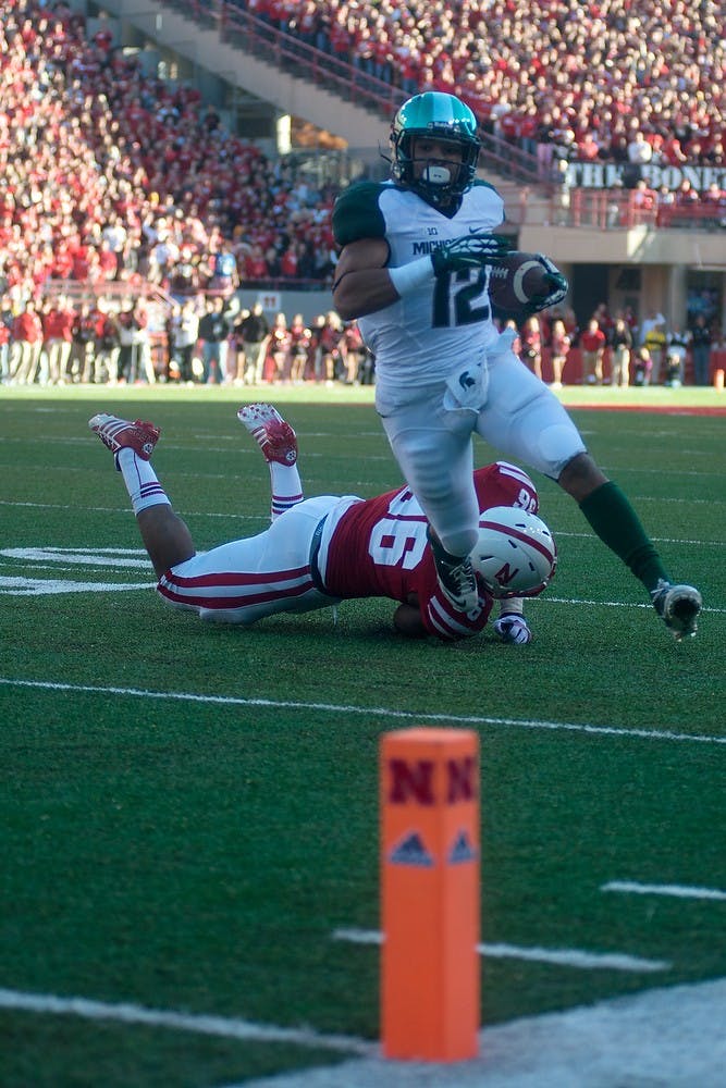 	<p>Freshman running back R.J. Shelton runs for a touchdown Nov. 16, 2013, at Memorial Stadium in Lincoln, Neb. The Spartans lead against the Cornhuskers at the half, 20-7. Julia Nagy/The State News </p>