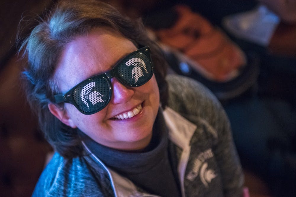 Hamden, Conn. resident and 1987 MSU alumna Mary DeLuca poses for a portrait before the Big Ten Men's Basketball semifinal game between Michigan State and Michigan on March 3, 2018 at Mustang Harry's in New York. Between one and two hundred MSU fans and alumni gathered at Mustang Harry's before the game. (Nic Antaya | The State News)