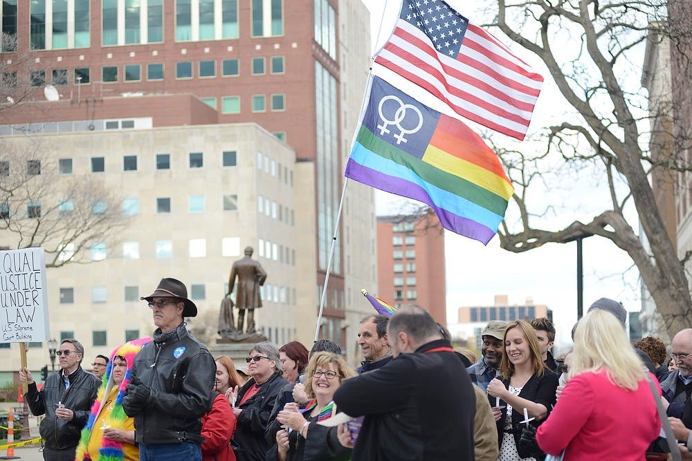 <p>People support same-sex marriage April 27, 2015, at the Lansing Capitol. The vigil was held in anticipation of the same-sex marriage trials in the U.S. Supreme Court. Hannah Levy/The State News</p>