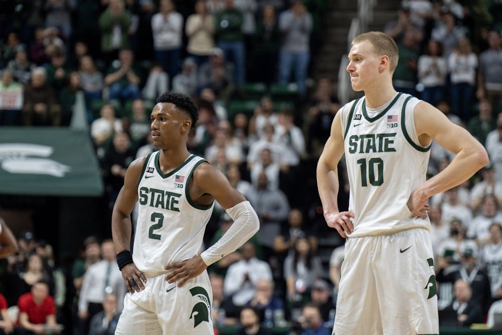 <p>Spartan teammates Tyson Walker and Joey Hauser at the end their game against Ohio State. Michigan State won 84-78.</p>