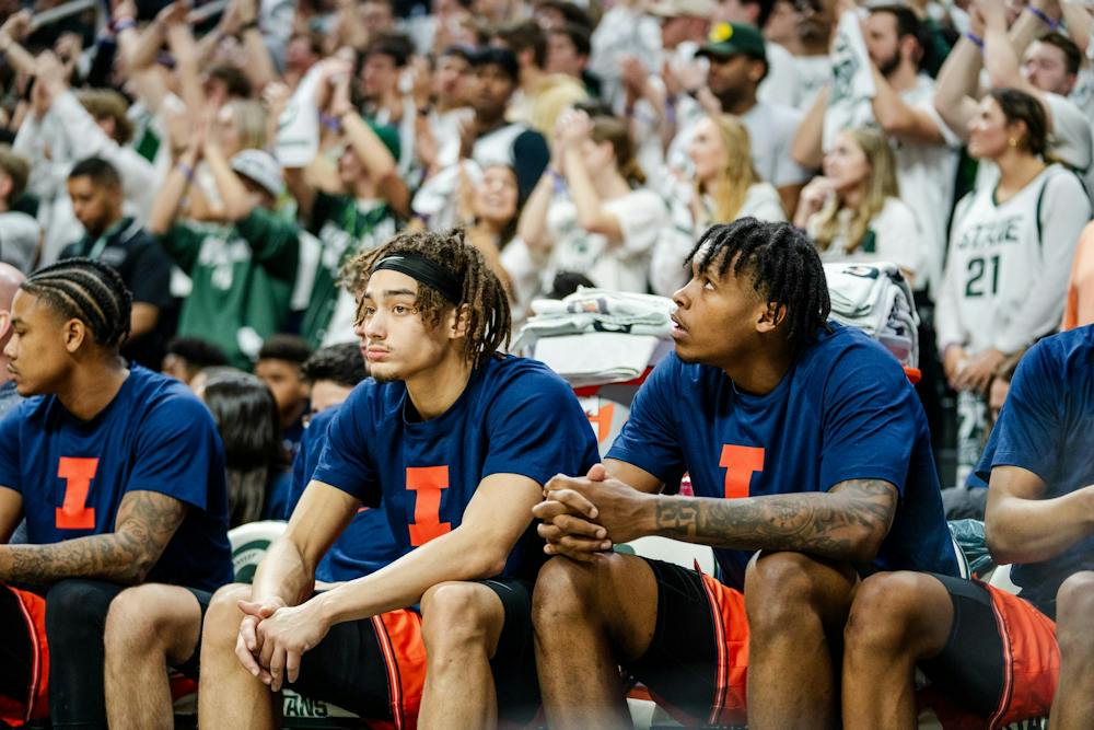 <p>The University of Illinois teammates watch from the bench as Izzone members get loud behind them at the Breslin Center on Feb. 10, 2024. Michigan State beat the University of Illinois 88-80.</p>