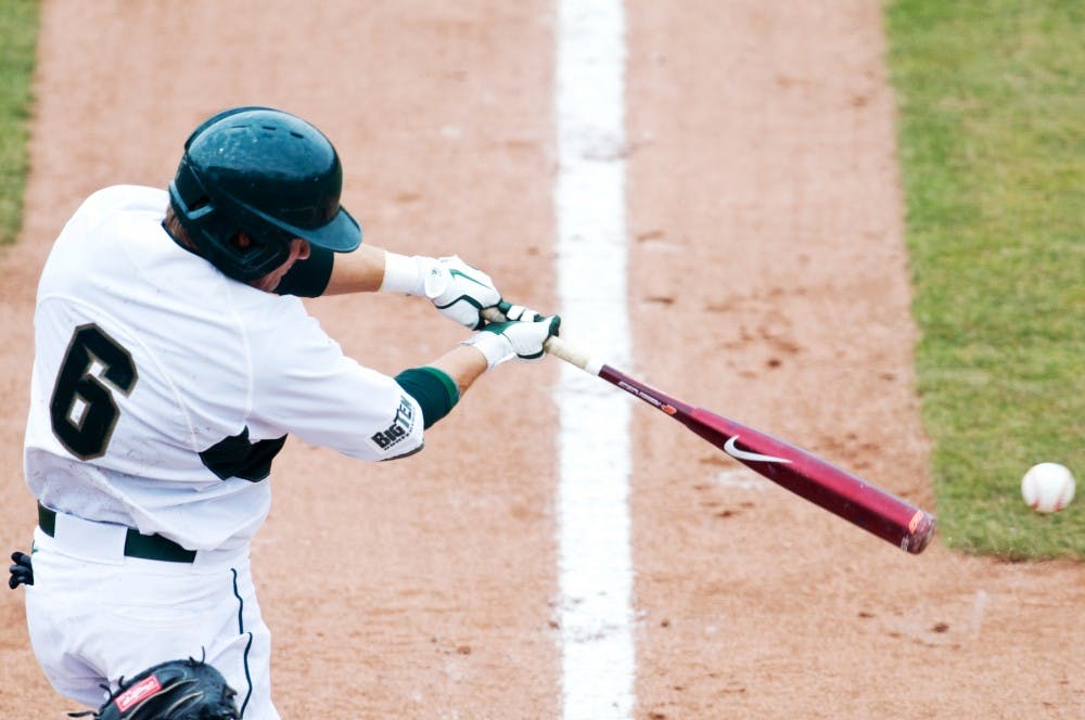 Sophomore outfielder Jordan Keur swings at the ball in the first game of a three-game series against Minnesota Friday afternoon. The Spartans defeated the Golden Gophers in Friday's game, 4-2. Matt Hallowell/The State News