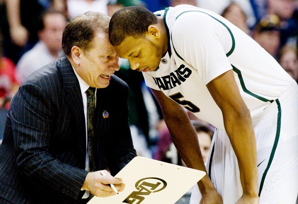 Head coach Tom Izzo shows sophomore center Adreian Payne a play on the sideline Sunday afternoon at Nationwide Arena, Columbus, Ohio. Payne grabbed seven rebounds in the 65-61 Spartan victory over the St. Louis Billikens. Jaclyn McNeal/The State News. 