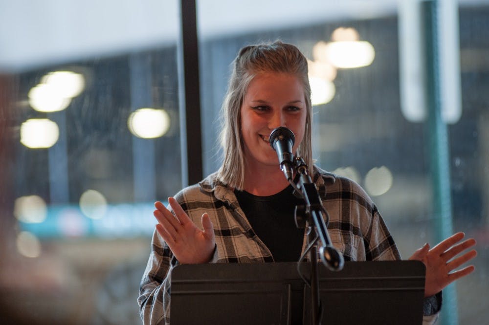 <p>Arts and humanities senior Sarah Teppen recites poetry on April 5, 2016 at (SCENE) Metrospace at 110 Charles St in East Lansing. People recited poetry in many different languages.</p>