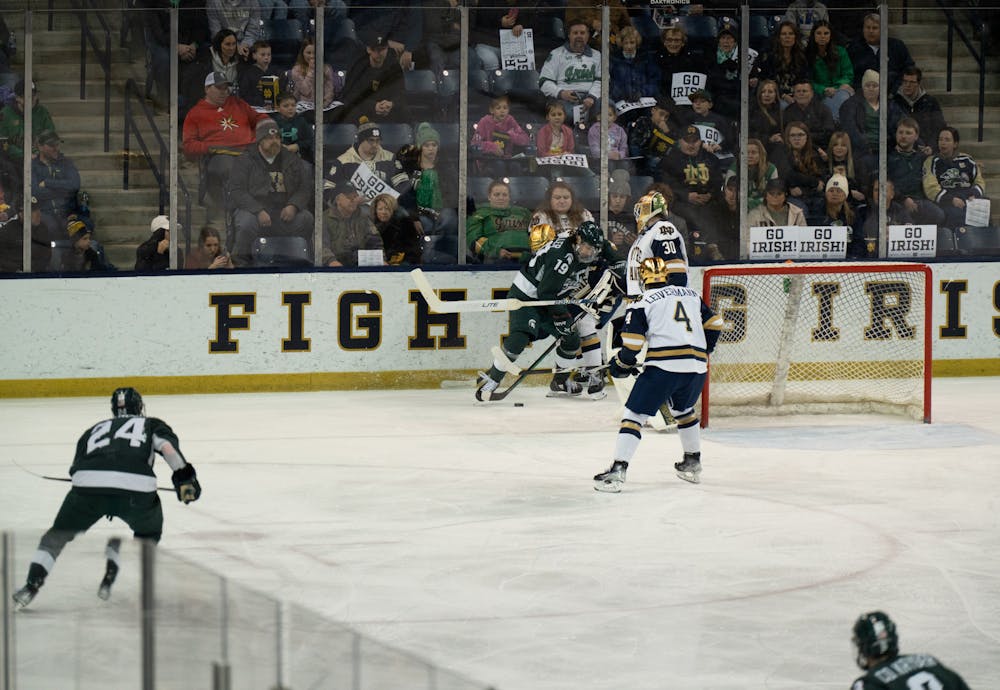 <p>Spartan center Nicolas Müller battles for the puck along the boards at Compton Family Ice Arena in Notre Dame, IN on Friday, March 4, 2023. Müller recorded 2 assists in the 4-2 victory over Notre Dame.</p>