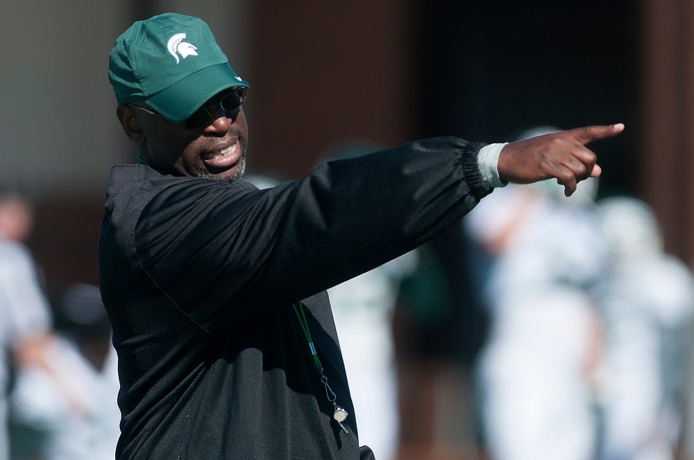 	<p>Secondary coach Harlon Barnett leads a practice drill Aug. 14, 2013, at the practice field outside Duffy Daugherty Football Building. Julia Nagy/The State News</p>