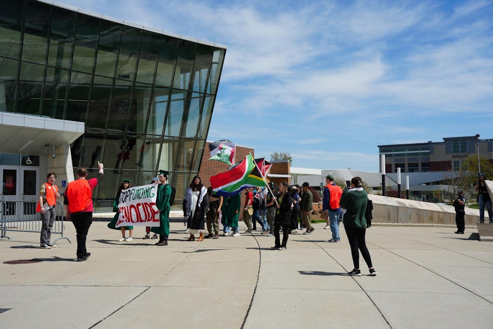 Student protestors arrive at the MSU Breslin Center to picket the ongoing spring convocation on April 26, 2024. They chanted, "Trustees, trustees you can't hide, you are funding genocide."
