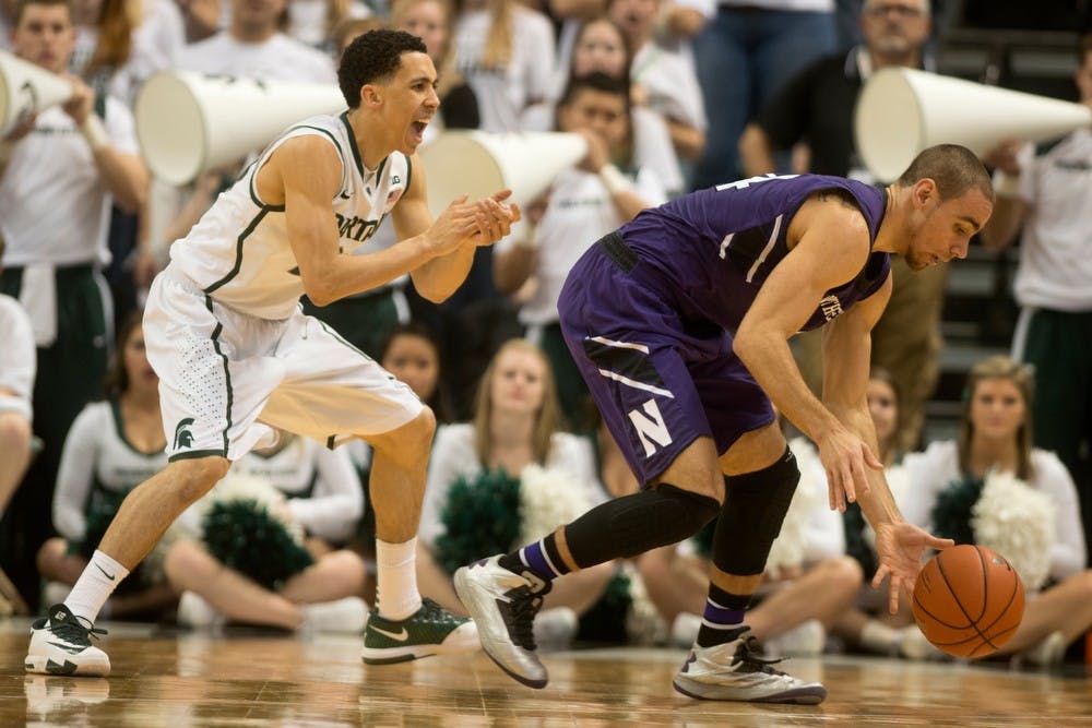 	<p>Junior guard Travis Trice applies pressure to Northwestern guard Tre Demps on Feb. 13, 2014, at Breslin Center. The Spartans lead at half, 39-30. Julia Nagy/The State News</p>