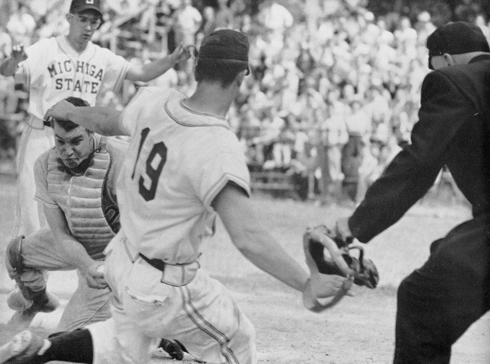 Dan Brown hits the dirt in vain as the Ohio State catcher clenches the ball for the tag. (1995)