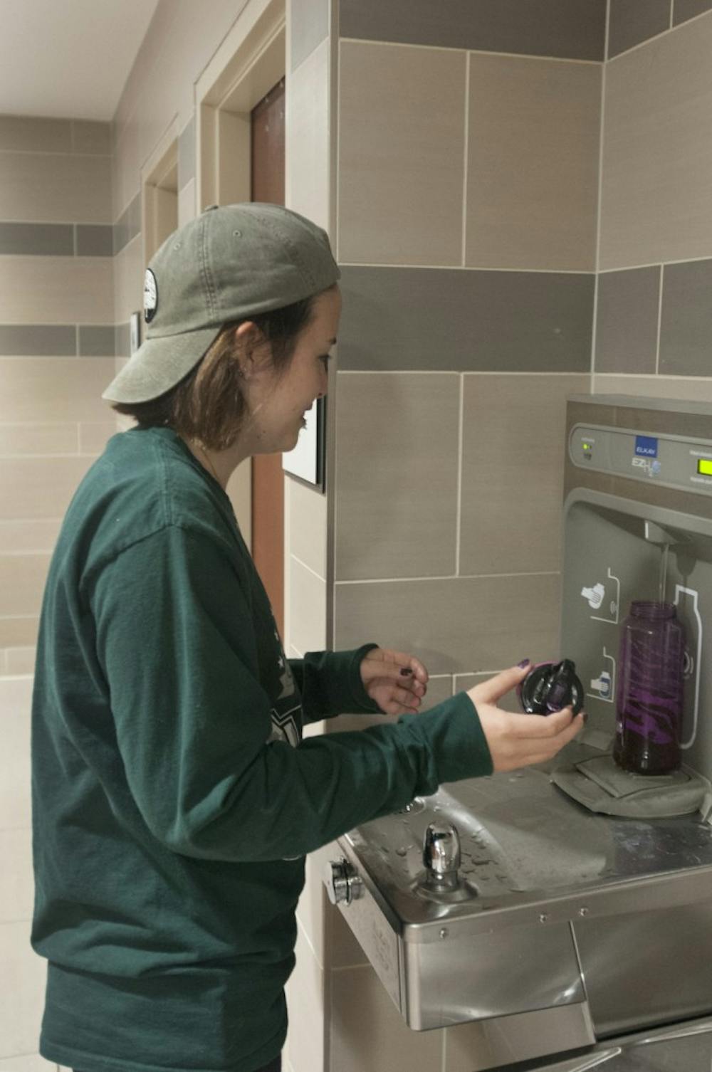 Human biology junior Nina Rackerby fills her water bottle at a drinking fountain in the Union. Rackerby said she had used fountains like this one on campus before.