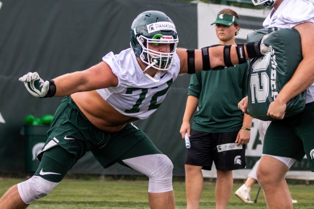 <p>Junior defensive tackle Mike Panasiuk (72) goes through a drill during practice on Aug. 2, 2018 at Duffy Daugherty Football Building.&nbsp;</p>