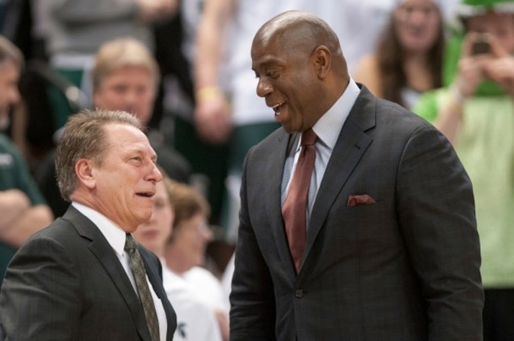 Men’s basketball head coach Tom Izzo, left, laughs with former MSU basketball player Magic Johnson before the game against Indiana on Feb. 19, 2013, at Breslin Center.