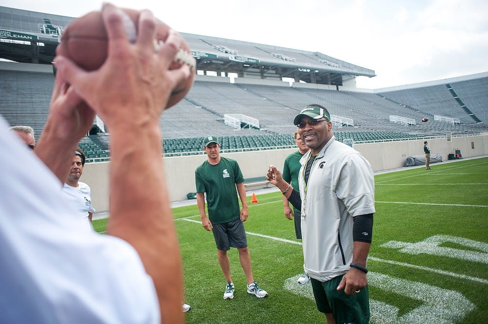 	<p>Wide receivers coach Terrence Samuel talks with other Spartan Fantasy Football Camp participants, June 11, 2013, at Spartan Stadium. The two-day event allowed <span class="caps">MSU</span> football fans to tour <span class="caps">MSU</span> facilities and practice at Spartan Stadium. Justin Wan/The State News</p>