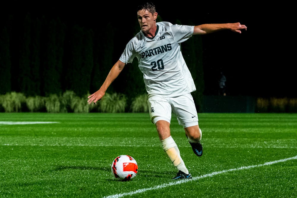 <p>Redshirt senior defender Connor Brazil balances on the out-of-bounds line. Michigan State men&#x27;s soccer team defeated Duquesne 1-0 on Sept. 21, 2021 in East Lansing.</p>