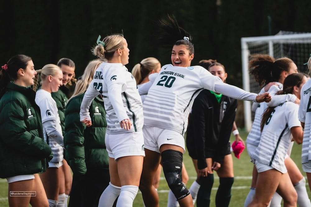 MSU junior defender Ella Janz (22) chestbumps with her teammate at the DeMartin Soccer Stadium in East Lansing, MI, on Nov. 23, 2025.
